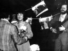 Apartment of Olga Serova and Evgeny Kozhevnikov. Actors receive flowers after their play “Refuseniks”. Moscow, end of 1978. co RS